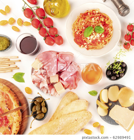 Italian food square overhead shot. Pizza, pasta, cheese, ham, capers, wine, tomatoes, olives and olive oil, shot from the top on white 62989491