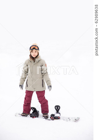 A woman snowboarding A woman snowboarding 62989638