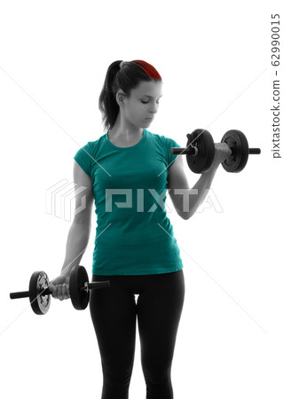 Sporty young woman doing bicep curls with Sporty young woman doing bicep curls with 62990015