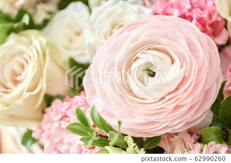 Spring bouquet in a wicker basket.. Learning flower arranging, making beautiful bouquets with your own hands. Flowers delivery Spring bouquet in a wicker basket.. Learning flower arranging, making beautiful bouquets with your own hands. Flowers delivery 62990260