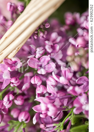 Spring bouquet in a wicker basket.. Learning flower arranging, making beautiful bouquets with your own hands. Flowers delivery 62990262