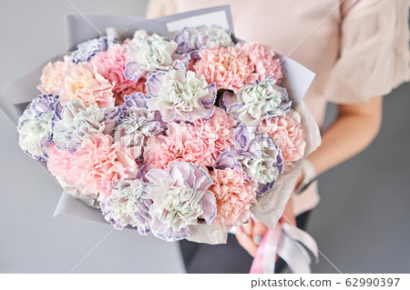 Bouquet of carnation flowers pastel color. Spring bunch in woman hand. Present for Mothers Day. Bouquet of carnation flowers pastel color. Spring bunch in woman hand. Present for Mothers Day. 62990397