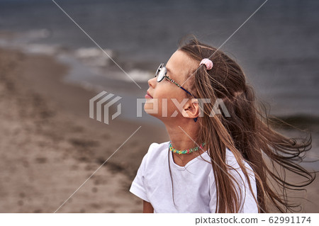 Portrait of a teenage girl in glasses and a white Portrait of a teenage girl in glasses and a white 62991174