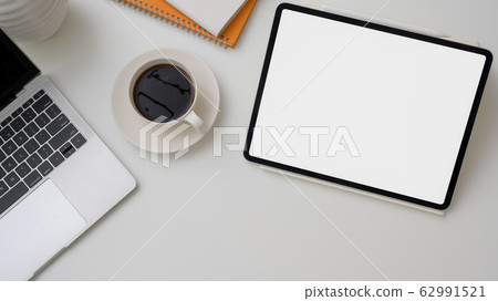 Top view of workplace with mock-up tablet, laptop Top view of workplace with mock-up tablet, laptop 62991521