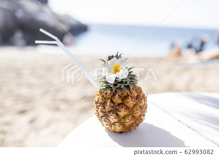 Pineapple cocktail on the beach 62993082