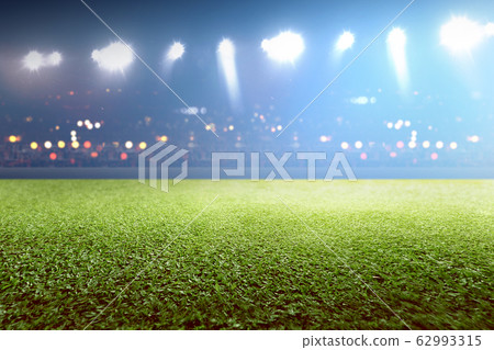 Green grass and tribune with blurred lights 62993315