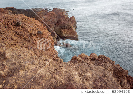 Rocky ocean coast with steep precipice Rocky ocean coast with steep precipice 62994108