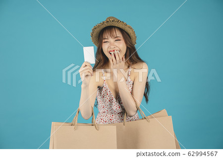 Asian girl carrying shopping bags with summer dress and enjoys shopping.  62994567