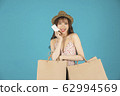 Asian girl carrying shopping bags with summer dress and enjoys shopping.  62994569