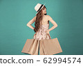 Asian girl carrying shopping bags with summer dress and enjoys shopping.  62994574