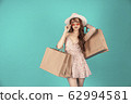 Asian girl carrying shopping bags with summer dress and enjoys shopping.  62994581
