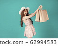 Asian girl carrying shopping bags with summer dress and enjoys shopping.  62994583