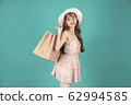 Asian girl carrying shopping bags with summer dress and enjoys shopping.  62994585