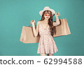 Asian girl carrying shopping bags with summer dress and enjoys shopping.  62994588