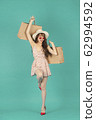 Asian girl carrying shopping bags with summer dress and enjoys shopping.  62994592