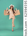 Asian girl carrying shopping bags with summer dress and enjoys shopping.  62994595