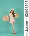 Asian girl carrying shopping bags with summer dress and enjoys shopping.  62994598