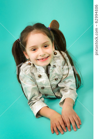 Cute young girl lost a tooth. 62994886