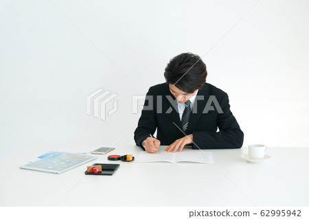 Businessman writing documents Businessman writing documents 62995942