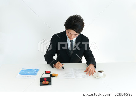 Businessman stamping 62996583