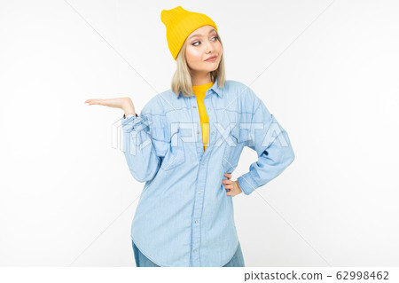 stylish blonde girl in casual look with holding hand with a template on a white background stylish blonde girl in casual look with holding hand with a template on a white background 62998462
