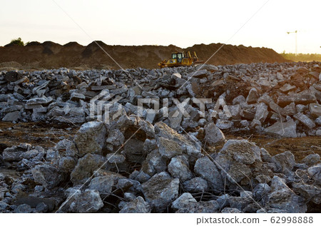 Background of broken and destroyed asphalt at a construction site. Background of broken and destroyed asphalt at a construction site. 62998888