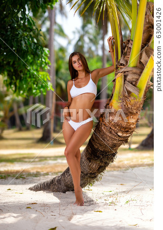 Beautiful girl in white bikini posing at the Beautiful girl in white bikini posing at the 63001426