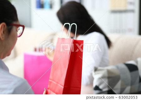 Female office worker looking at shopping bags 63002053