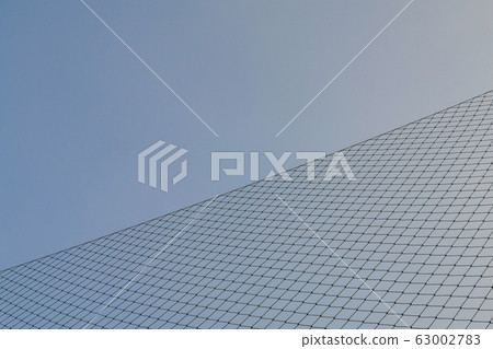 Metal crossed gate against sunlight and blue sky Metal crossed gate against sunlight and blue sky 63002783