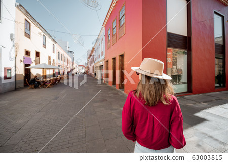 Stylish woman walking the street in the old town 63003815