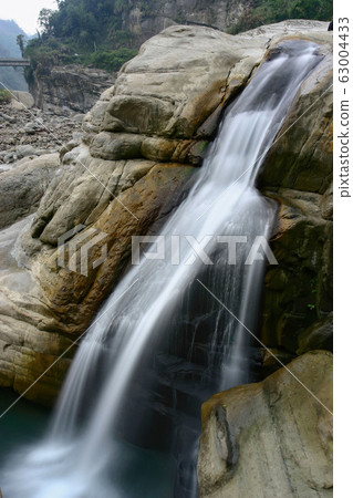Long time exposure shot of a creek and rocks Long time exposure shot of a creek and rocks 63004433