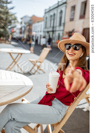 Happy woman resting on the cafe terrace in the old city 63004565