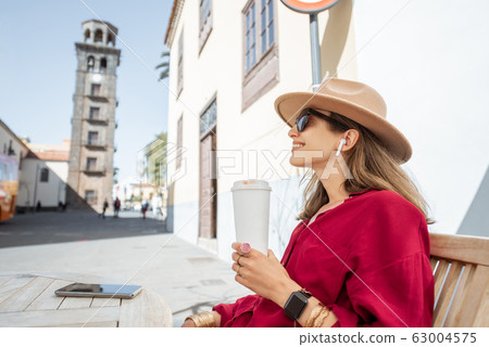 Happy woman resting on the cafe terrace in the old city 63004575