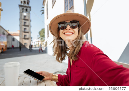 Happy woman resting on the cafe terrace in the old city 63004577