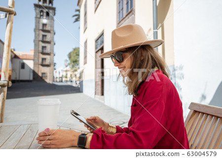 Happy woman resting on the cafe terrace in the old city 63004579