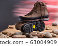 Pair of walking boots in the studio. 63004909