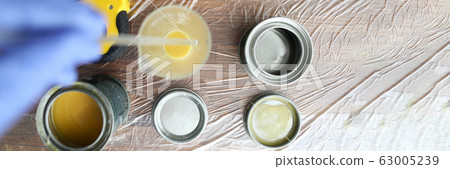 On wooden surface are cans varnish and stain On wooden surface are cans varnish and stain 63005239