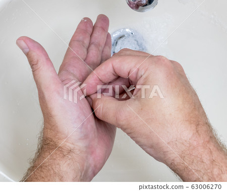 Man washing hands close-up from above Man washing hands close-up from above 63006270