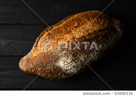 French bread on a black wooden table 63006316