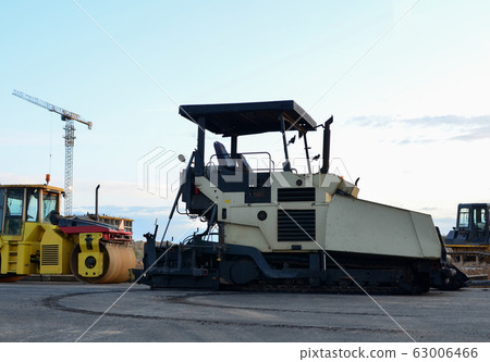 Road roller working at construction site during asphalt road repair 63006466