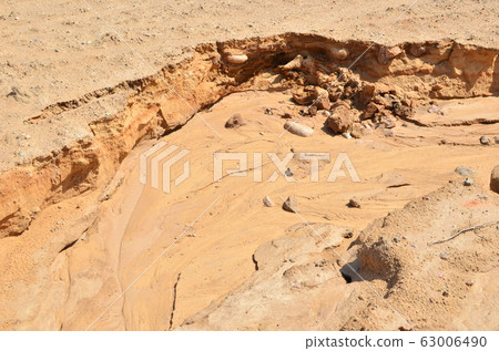 Background of yellow sand with small stones after rain Background of yellow sand with small stones after rain 63006490