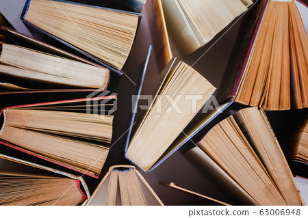 Old and used hardcover books or textbooks visible 63006948