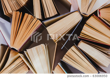 Old and used hardcover books or textbooks visible 63006950