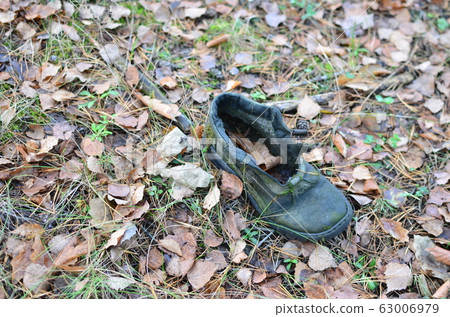 Man's shoes on a ground in the forest. Man's shoes on a ground in the forest. 63006979