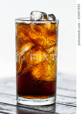 cola drink with ice in glass on wood table 63007895