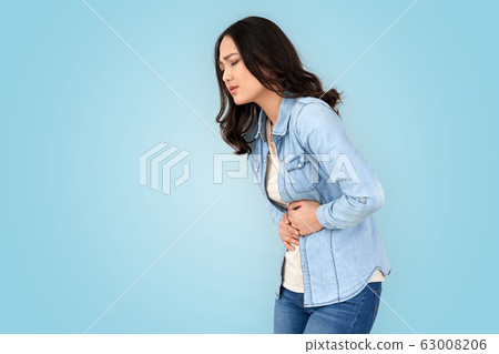 Coronavirus Concept. Chinese woman standing isolated on grey having stomachache wincing 63008206