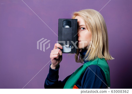 Style blonde woman in 80s clothes with VHS Style blonde woman in 80s clothes with VHS 63008362
