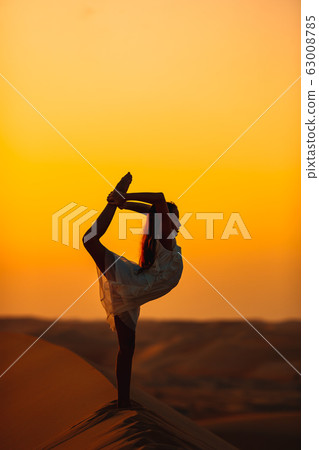 Girl among dunes in Rub al-Khali desert in United Arab Emirates 63008785