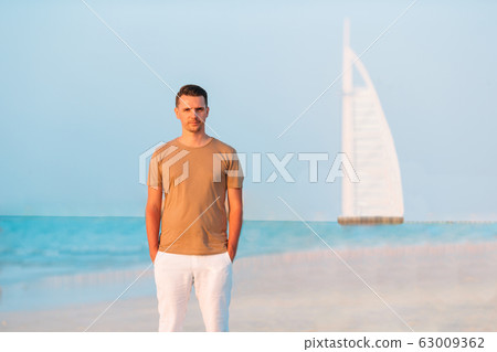 Young man on the beach having fun 63009362