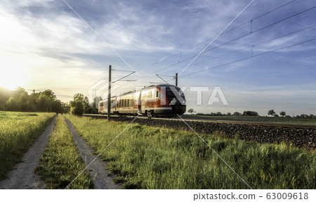 Passenger train on sunny day of summer in Germany Passenger train on sunny day of summer in Germany 63009618